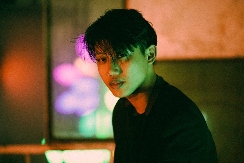 Portrait of an adult with colorful neon lights at night. Captivating atmosphere in Hồ Chí Minh City.